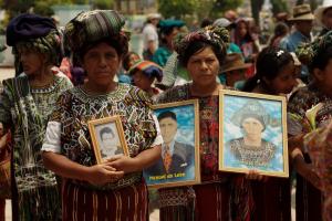 In Nebaj, Maya Ixil women hold portraits to commemorate loved ones lost during Guatemala’s 36-year civil war. Photo by Graham Charles Hunt