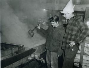 Barbara and Bruce Cole ’59, in de rigueur post-agricultural fashions, test the boiling sap for thickness in Marlboro’s own sugarhouse.