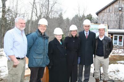 President Ellen McCulloch-Lovell celebrates the groundbreaking with special guests Charles and Sue Snyder, chairman Dean Nicyper, art faculty member Tim Segar, and Dan Cotter, director of plant operations, the only one without a hardhat or a coat.  