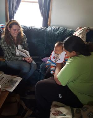 Cait Mazzarela interviews a family at Pine Ridge Reservation, South Dakota, part of a community engagement and service learning trip last April. Photo by Ian Grant ’17 