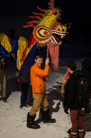  Seth Harter, professor of Asian studies and history, heads up the dragon dance celebrating the lunar new year and ushering in the Year of the Rooster in January. The celebration also included calligraphy, tea, and plentiful dumpling making (and eating). Photo by Clayton Clemetson 