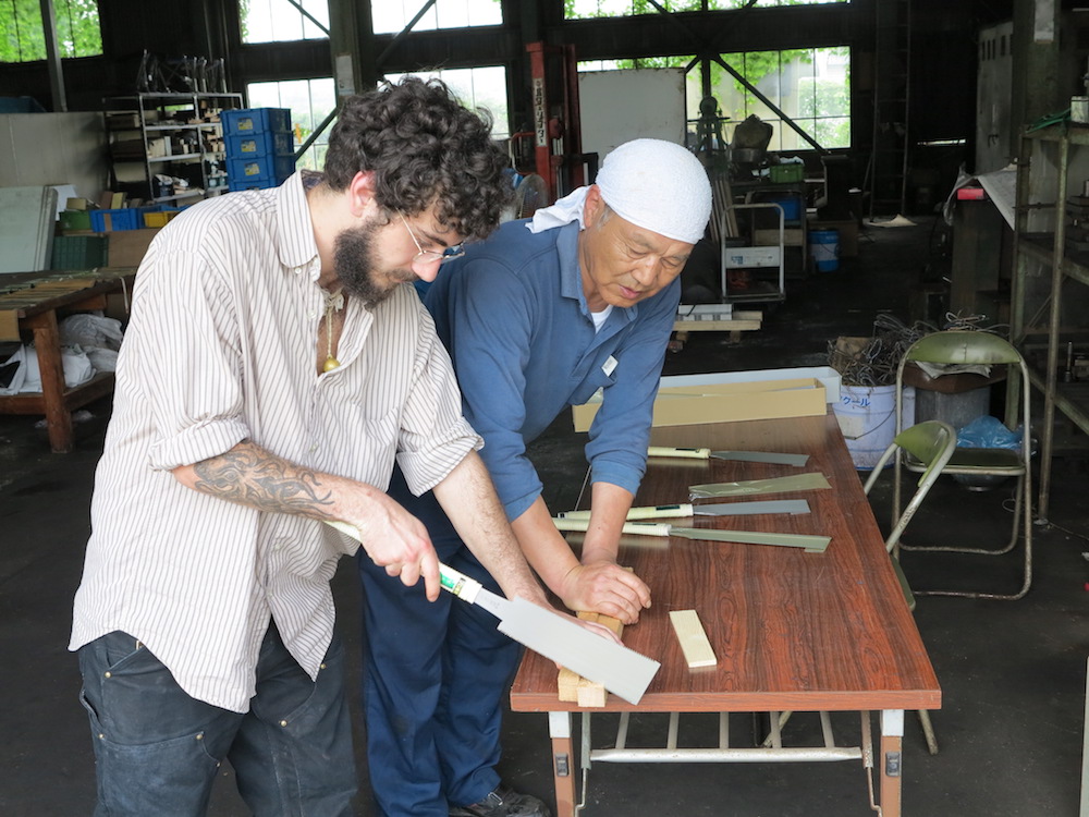 Salvatore Annunziato tests out a Ryoba-style saw at Hishika Saw Works, in Miki City, Japan, with one of the leaders and master craftsmen there.