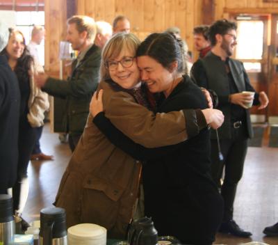 Theater professor Brenda Foley and writing and literature professor Bronwen Tate share a moment during a trustee tea in November, soon after the Emerson alliance was announced. Photo by Clement Goodman ’22 