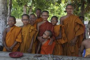 Young monks at the Ang Pagoda try out some of the donated eye glasses brought by the visitors from Vermont. Photo by John Willis