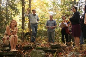 The class explores the site of the former Bishop homestead, at the base of Hogback Mountain, with the help of stone wall expert Kevin Gardner.