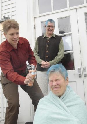 Jodi Clark dyes the hair of receptionist Sunny Tappan ’77, to the delight of Richard Glezjer, blue-haired dean of faculty. Photo by Philip Johansson