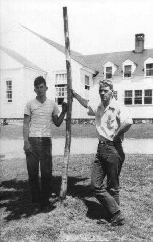 Robert and older brother John MacArthur Jr., now physics professor emeritus, sample the foliage height diversity of the recently planted tree in front of the dining hall.