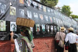 Community members visit the Association for Justice and Reconciliation’s exhibition titled “Photographic Memory,” depicting genocide victims. Photo by Chrissy Raudonis