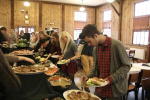 Students line up for local delicacies at the community dinner following the signing of the Real Food Challenge. Photo by Philip Johansson