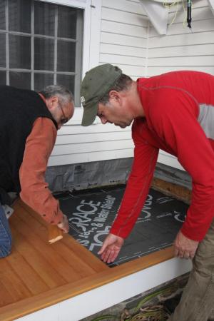 Photography professor John Willis and chemistry professor Todd Smith put the finishing touches on the front porch of Mather, where they helped replace weathered flooring during Work Day last fall.