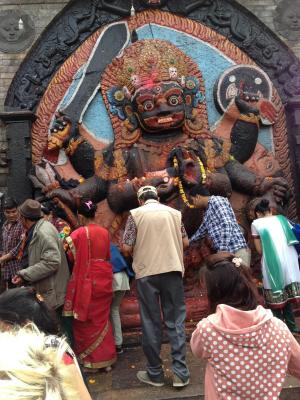 In Durbar Square, pilgrims flock around a shrine to Kali, the goddess of destruction, where they leave offerings, or puja. Photo by Blake Stanyon