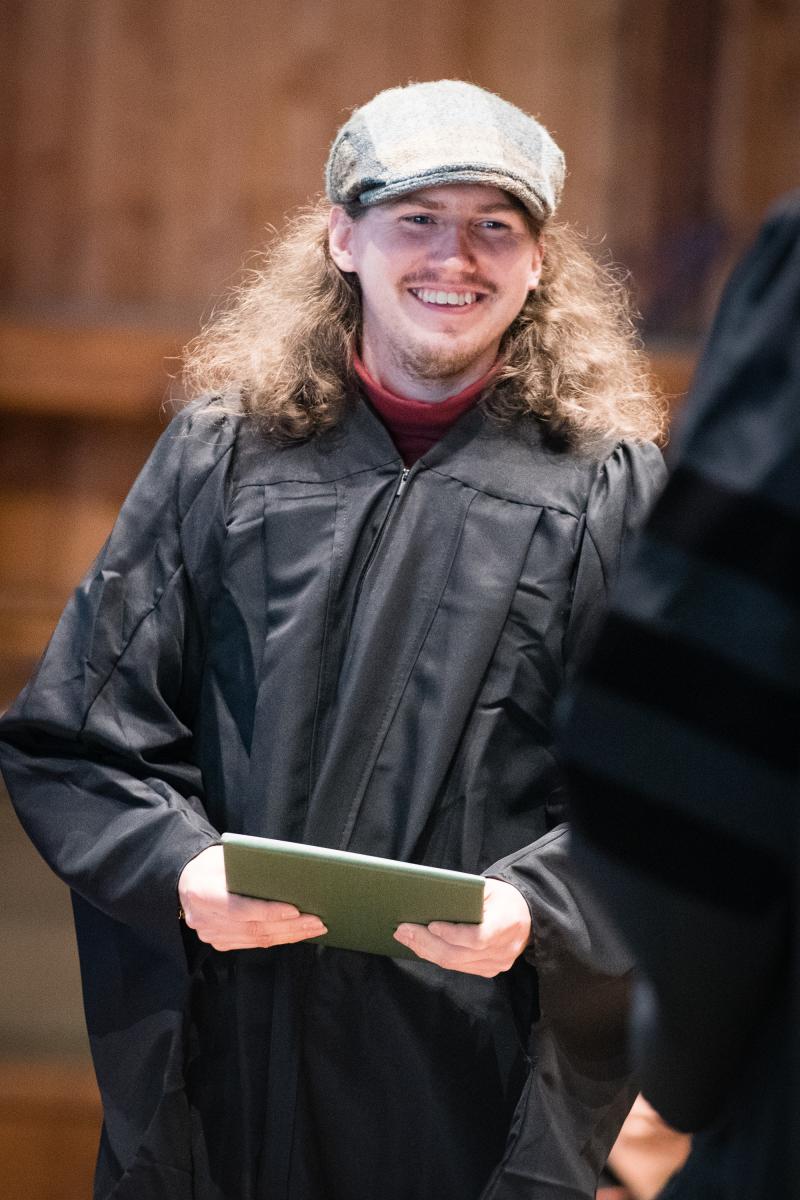 Adam Katrick graduates a second time in Persons Auditorium, receiving an MS in Management for his work educating the public about wolves. Photo by Jeff Woodward