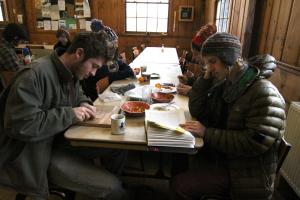 Freshman Cedar Van Tassel, left, carves a wood block during breakfast as part of his daily practice.