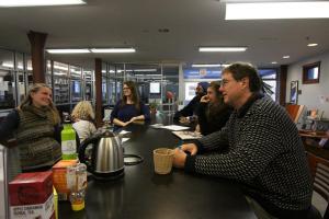 Maggie Patari, left, leads students and staff in a rousing game of international trivia at the library "research bar" during International Education Week.