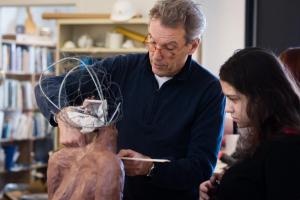 Tim shares techniques of figurative sculpture with junior Laura Wharton. Photo by Kelly Fletcher