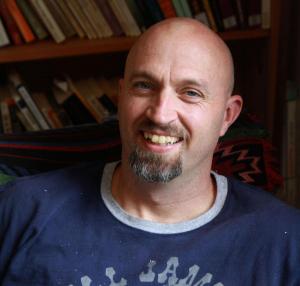 Literature and writing professor John Sheehy smiles when he thinks of books. Photo by Thea Cabreros ’13 